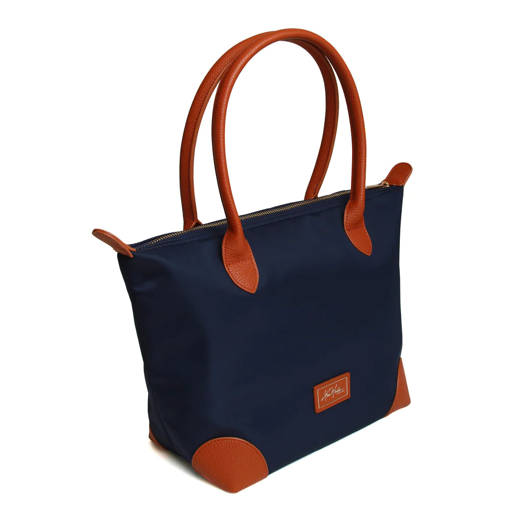 large navy tote bag with leather trimmings and a leather handle