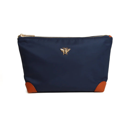 navy cosmetic bag with leather corners and a gold bee