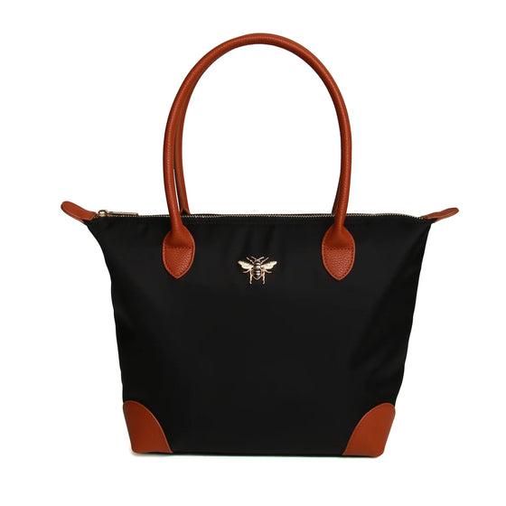 large black tote bag with leather trimmings, a leather handle and a gold bee on the front