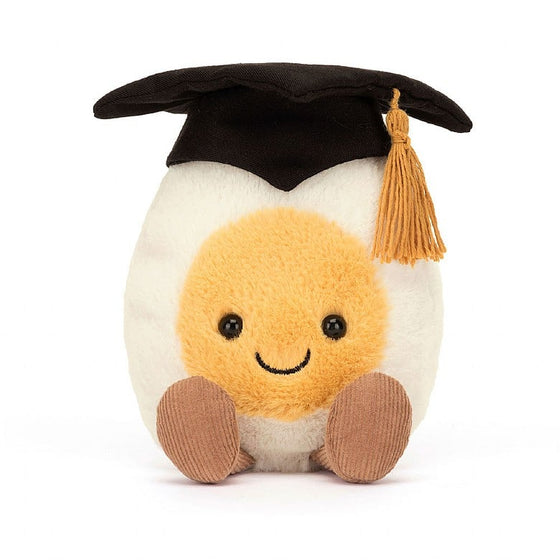 white egg with yellow face and smile, wearing black graduation cap with gold tassel