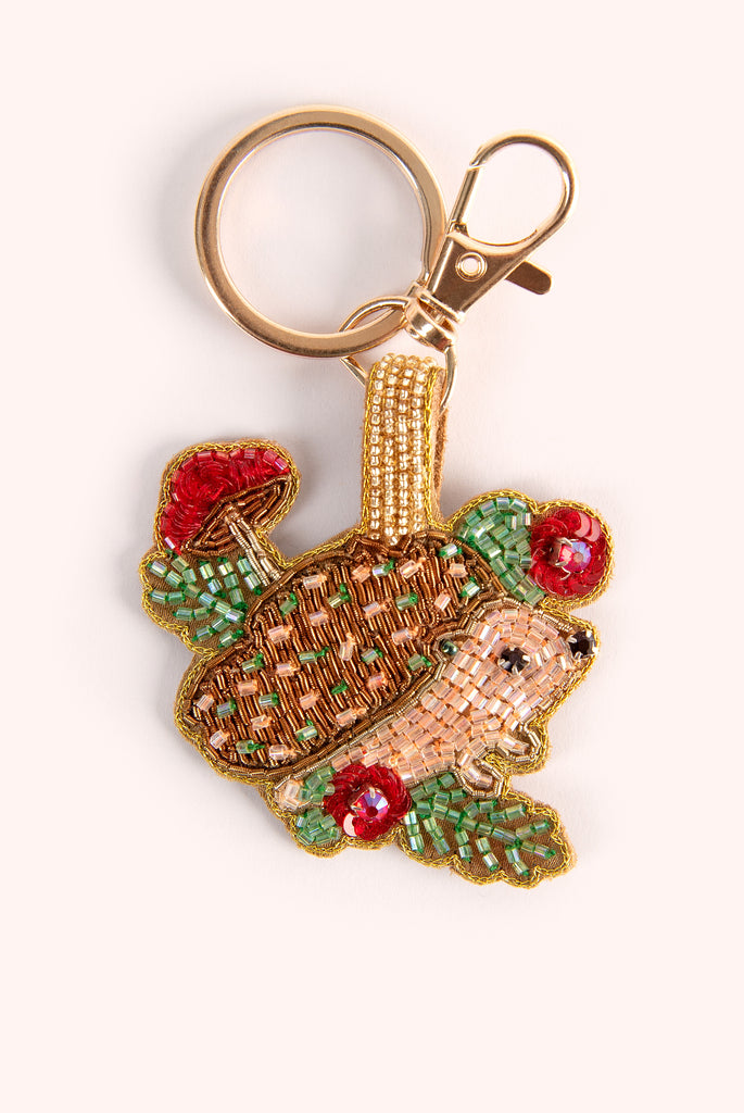 Decorative beaded key chain with a hedgehog design on a white background