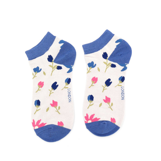 trainer socks with a silver background, bright blue toes, ankle cuff and heel with a blue and pink floral pattern