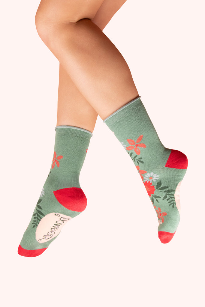 Green socks with floral patterns and red accents 