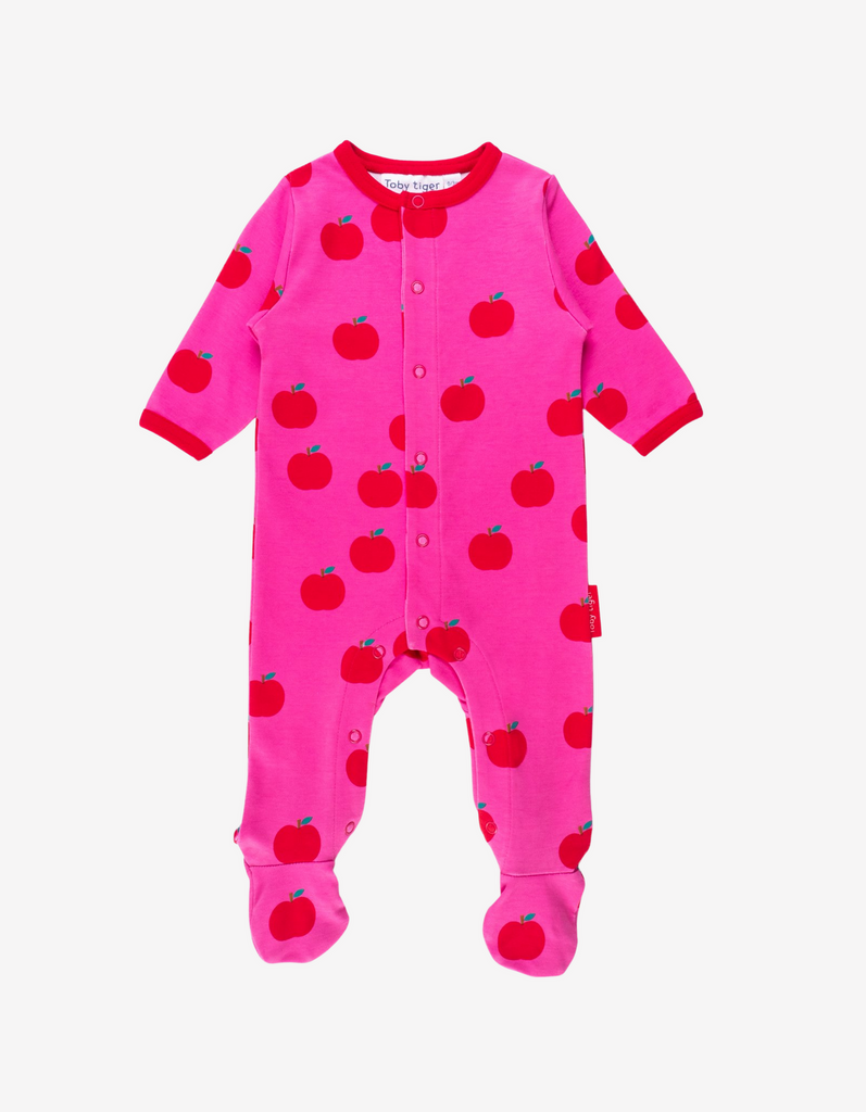 bright pink baby grow with a red apple print and red neckline and sleeves