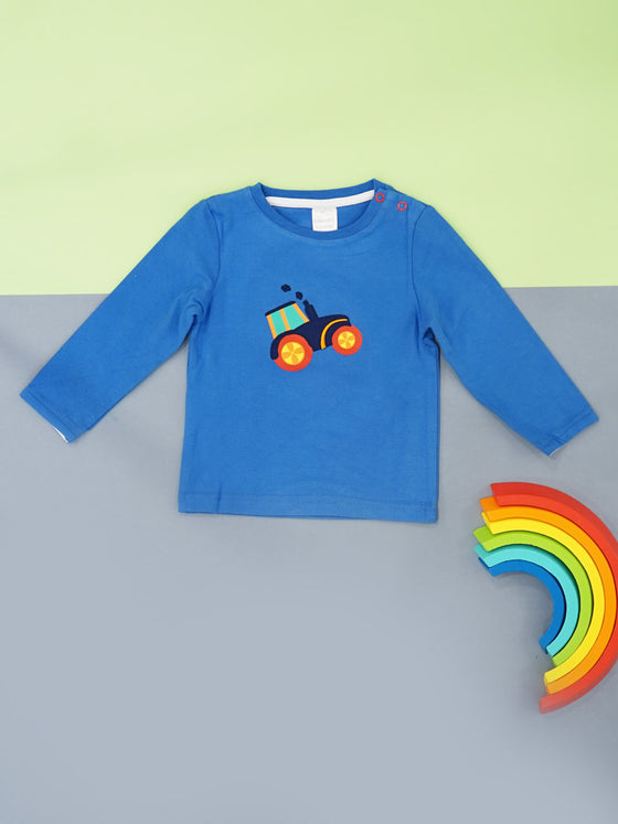 brught blue long sleeved top with a colourful tractor embroidery with big yellow and red wheels and a blue body puffing blue smoke