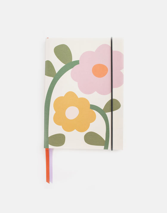 cream notebook with pink and orange flowers,  orange and lilac ribbon bookmarks and a strap for security