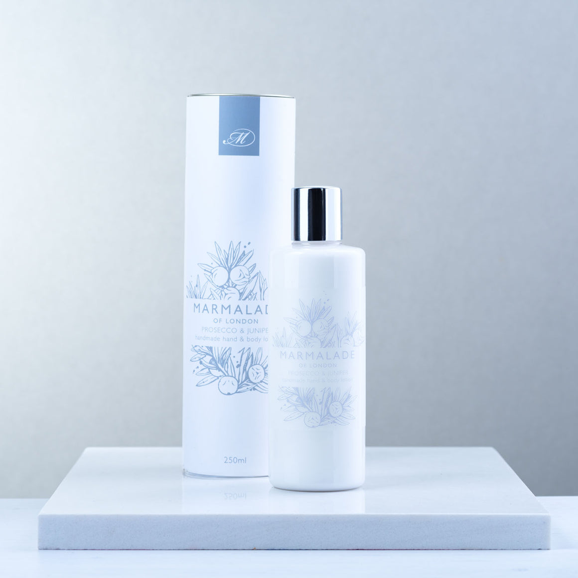 Marmalade of London Prosecco & Juniper Hand & Body Lotion with white packaging and light blue text