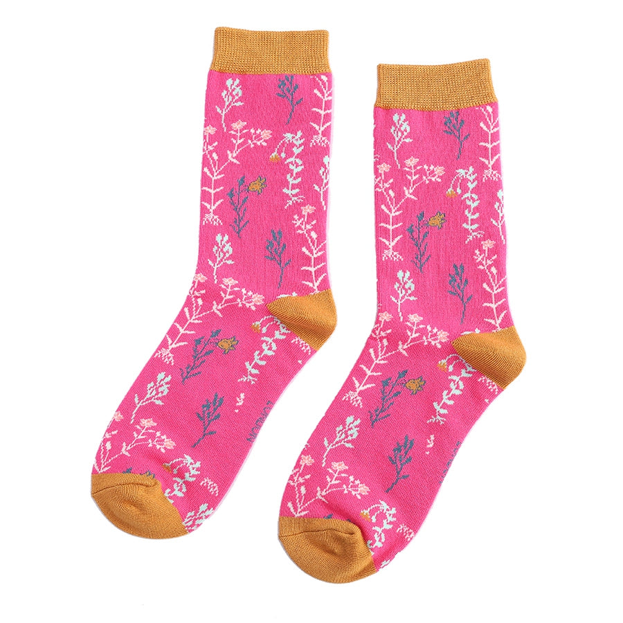 ankle socks with a hot pink background with a patetern of wild flowers and a mustard trim