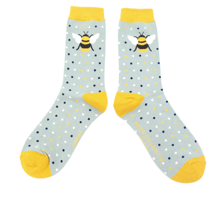 ankle socks with a duck egg blue background , yelow ankle cuffs, heels and toes tiny black, yellow and whiye dots with a bumble bee on the ankle