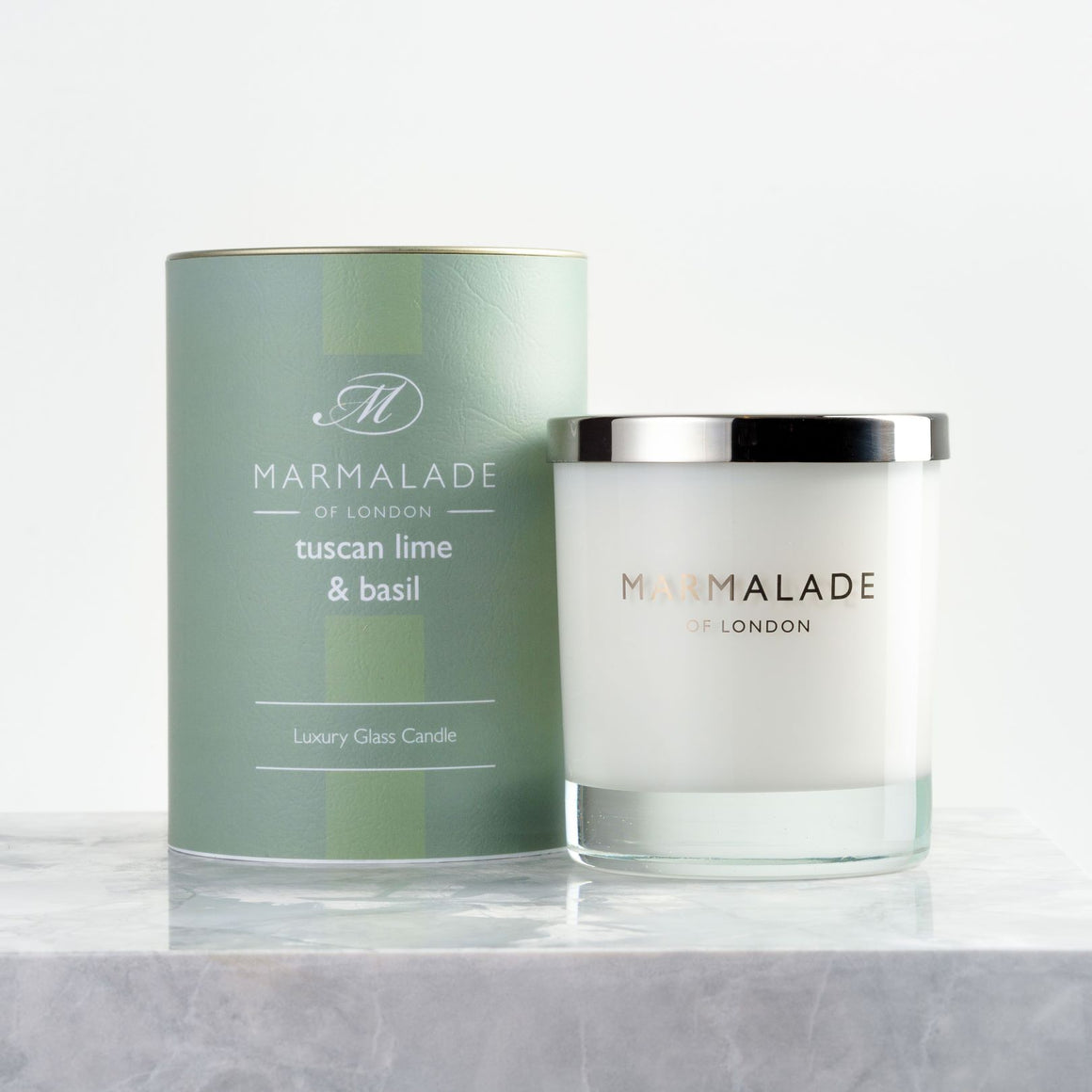 Marmalade of London Tuscan Lime & Basil Large Glass Candle, with  Base notes: Floral, Basil, Patchouli, Amber, Musk & Moss. Top notes: Mandarin, Lime, Grapefruit, Lemon and Spearmint. 