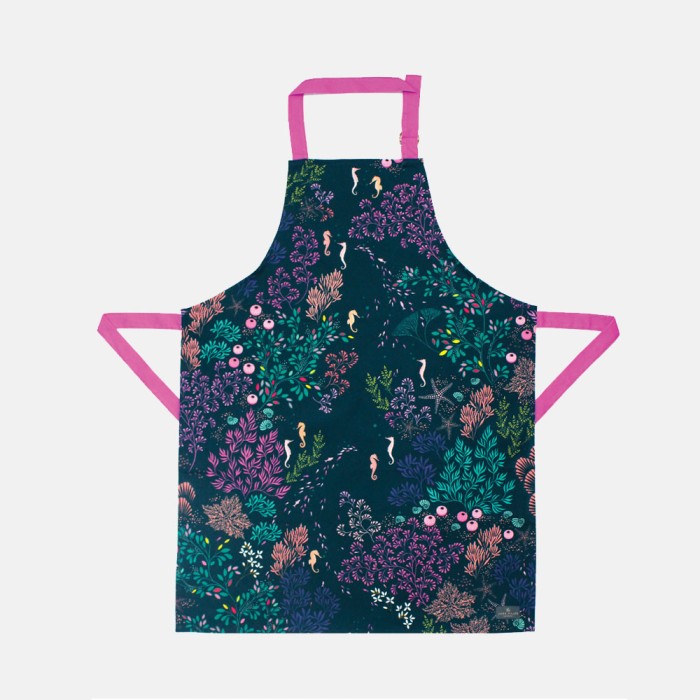 cotton sara miller apron with navy and deep purple green and pink under the water design with sea horses and a fushia strap